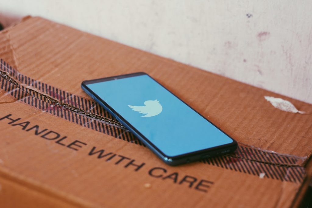 phone with Twitter logo on cardboard box